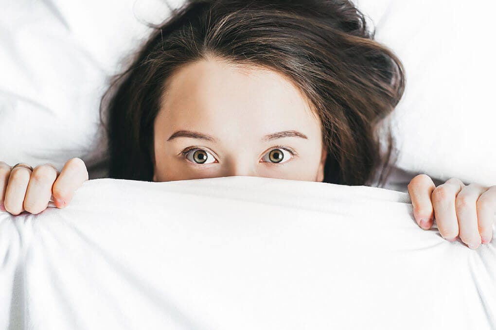 Girl hiding under sheets - featured image