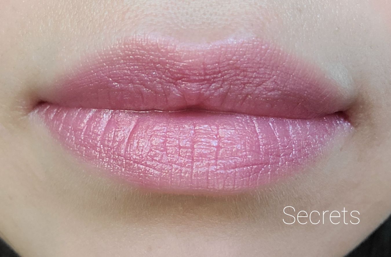 Image of close up lips wearing the lipstick in the shade called Secrets. This is a cool toned pink with golden shimmer.