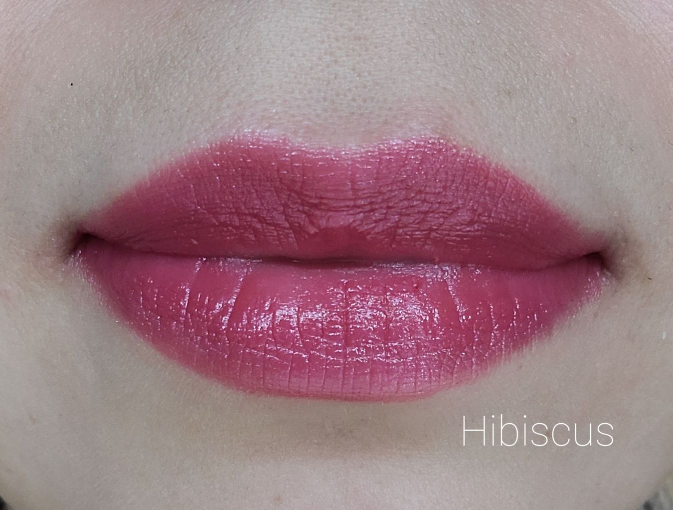Image of close up lips wearing lipstick in the shade called Hibiscus. This is a berry pink color with just a hint of red.