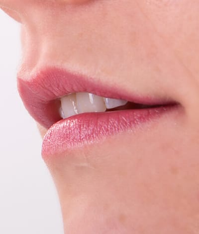 Image of close up lips on a light skin toned model wearing Mabel Lipstick by Red Apple Lipstick. Mabel is a gorgeous, long lasting mauve, rose pink