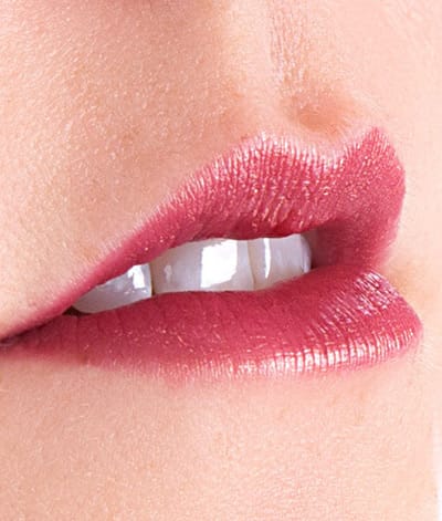 Image of a lady's close up lip wearing Plum Sexy Crazy lipstick. She has light skin tone.  Plum Sexy Crazy is a deep, multi-dimensional red plum color with a golden shimmer.
