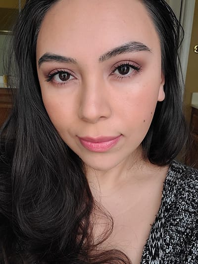 Image of female with long black hair wearing Red Apple Lipstick eyeshadows in the shades Porcelain, Made You Wink, Plums Up!, Heirloom, Hello Darkness, and Buttercream . She also is wearing Sundrop Bronzer and M'Lady blush