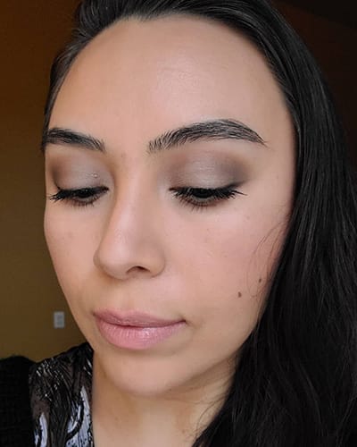 Image of female with black hair wearing Red Apple Lipstick Eyeshadows in the shades Porcelain , Earth Girl, Tip Taupe, Champagne, Buttercream and Hello Darkness as an eye liner. She is also wearing Sundrop Bronzer and Gotta Glow blush on her cheeks. 