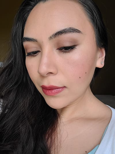 Image of female with long black hair wearing Red Apple Lipstick Eyeshadow in the shades Porcelain, Blondeshell, Tip Taupe, and Espresso. The Lash Project Mascara, Sundrop Bronzer, Coy Blush and Barely Pink Lip Liner