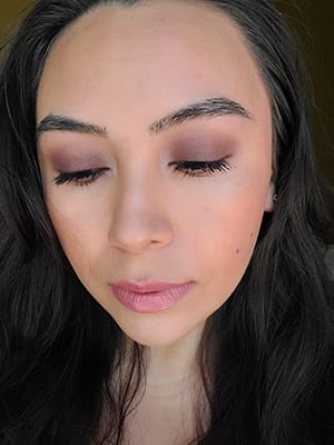 Image of lady with long black hair looking down to show all the eyeshadow colors that she used to complete the Smokey Eye look 