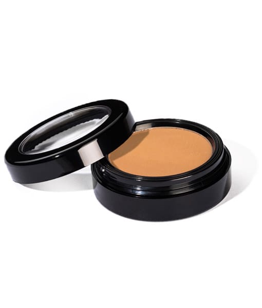 Image of Sundrop Bronzer by Red Apple Lipstick. Shown with top of compact open laying to the side and the color of the material seen. 