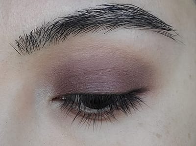 Image of close up eyelid after Buttercream eyeshadow has been applied as a highlight to the upper brow bone and the inner corner of the eye close to the tear duct.