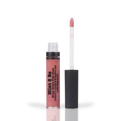 Image of lip gloss tube with the wand standing next to it in the shade called Honey Badger by Red Apple Lipstick. Honey Badger is a medium pigmented, smooth gloss with a touch of spearmint. It is nude with pink and brown undertones. It is not sticky or tacky, which provides a lovely and polished shine
