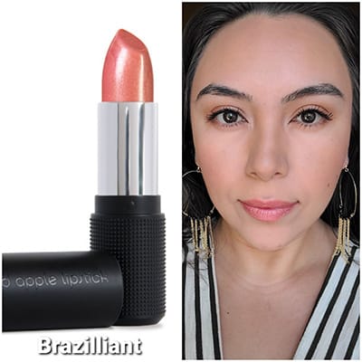 Image of Lipstick tube with cap off and color turned up on the left. On the right is a lady with long black hair and dark eyes wearing Braziilliant Lipstick by Red Apple Lipstick 