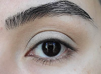 Image of close up eye with our model having dark brown eyes and dark eyebrows. She is featured 