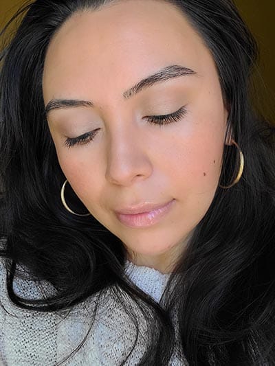Image of lady with long dark hair, dark eyes and brows with medium skin tone. She is featured here with her eyes looking down to show the eye lid colors used and after completing the Ethereal and Natural Summertime makeup look. All with Red Apple lipstick products.