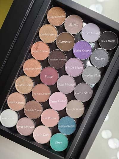 Image of large z palette style case displaying several eyeshadow pans in lots of different shades that Red Apple Lipstick has to choose from