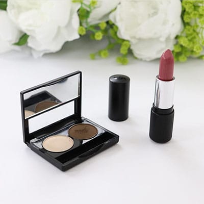 Image of Twosie Holder by Red Apple lipstick with 2 eyeshadow pans and one lipstick off to the side 