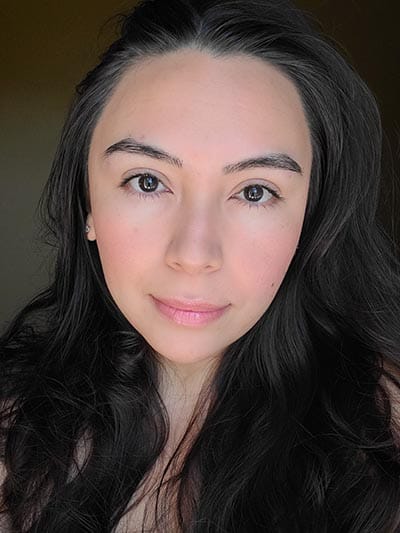 Image of lady with medium skin tone, long dark hair and dark eyes featured wearing only a bit of Sundrop Bronzer, Gotta Glow blush, Lash Project mascara, Rallye Balm, and Love Letter lipgloss