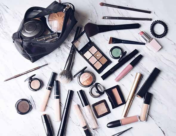 Image of makeup products and a makeup bag as a part of post talking about what to do with expired makeup and if it is bad to use expired makeup.