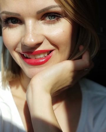 Image of barbara wearing a bold red lip perfect for fall makeup looks.