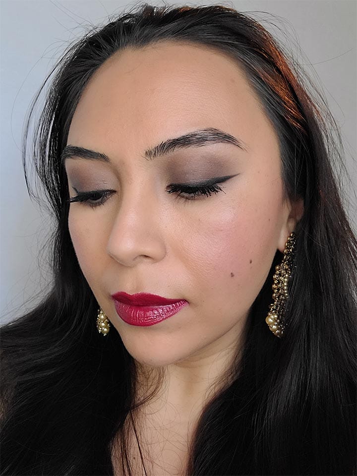 image of a girl wearing wedding guest makeup winter with eyes down