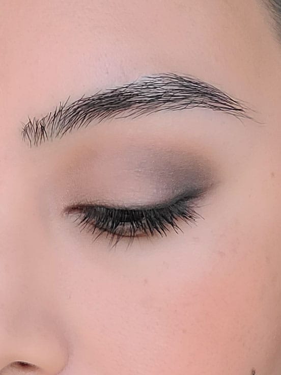 A woman's eye lid wearing a classic 3 eye shadow look.