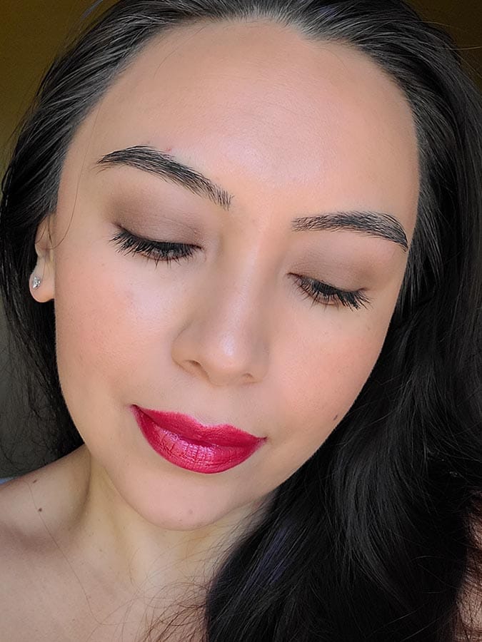 glam red lip makeup look on girl looking down 